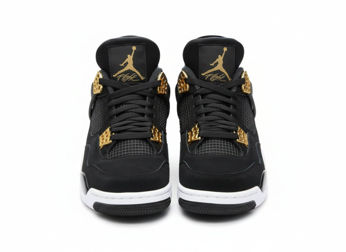 Black sneakers with gold accents on a textured gray surface